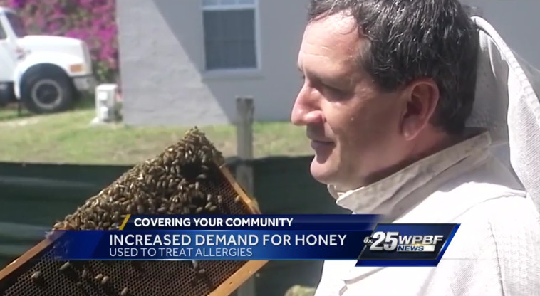 Craig Spense Holds up a Bee Frame Steve Byers